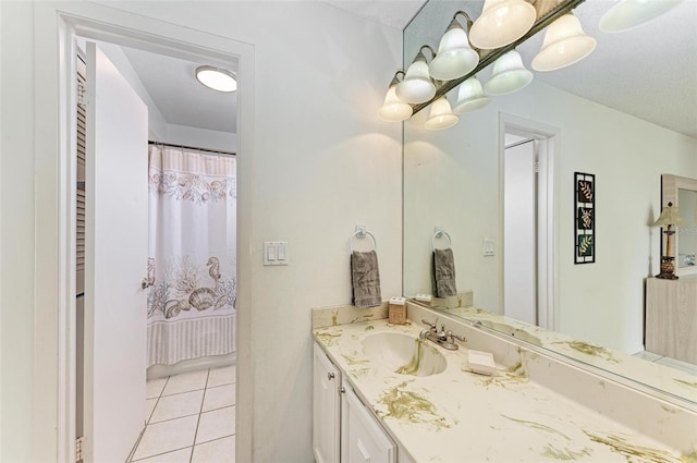 bathroom with curtained shower, vanity, and tile patterned floors