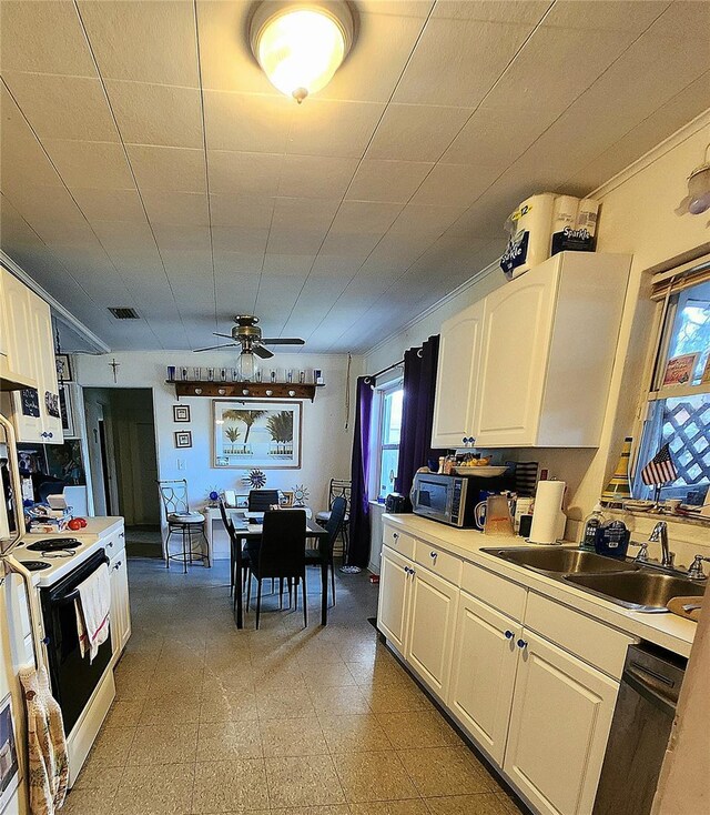 kitchen with dishwasher, white range with electric stovetop, white cabinetry, ceiling fan, and sink