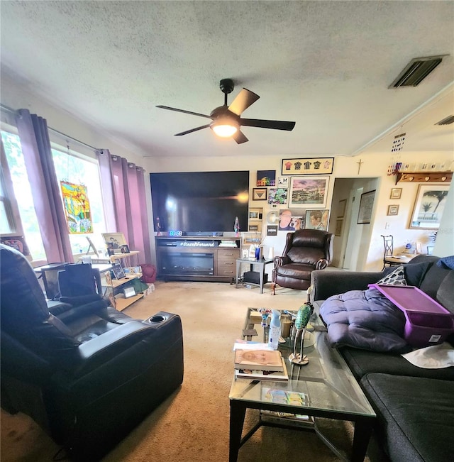 carpeted living room featuring a textured ceiling and ceiling fan