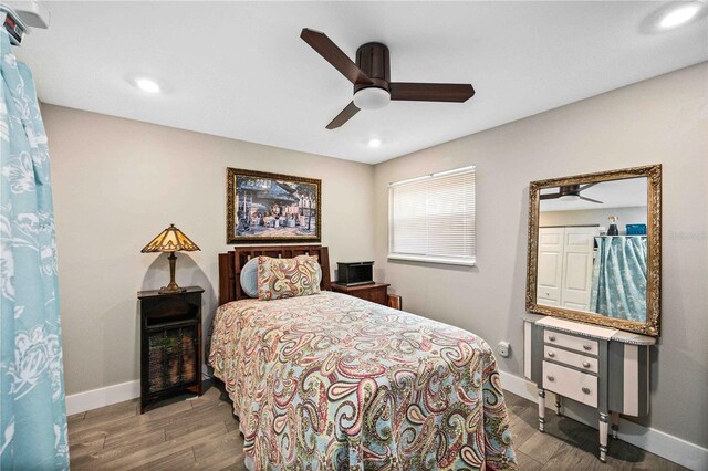 bedroom with wood-type flooring and ceiling fan