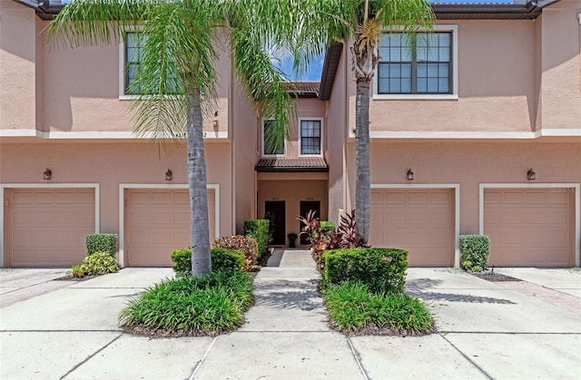 multi unit property featuring a garage