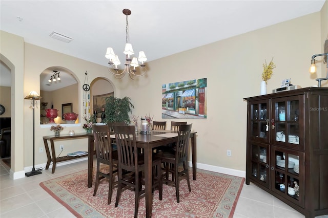 tiled dining area with a notable chandelier