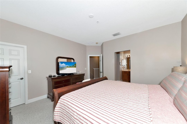 carpeted bedroom featuring ensuite bathroom