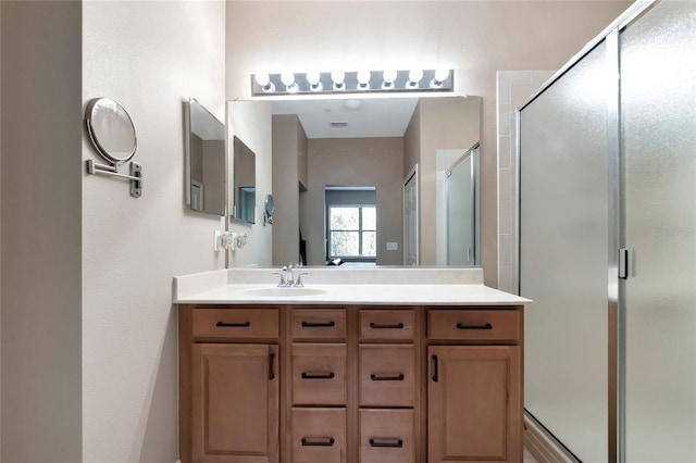 bathroom with vanity and a shower with shower door