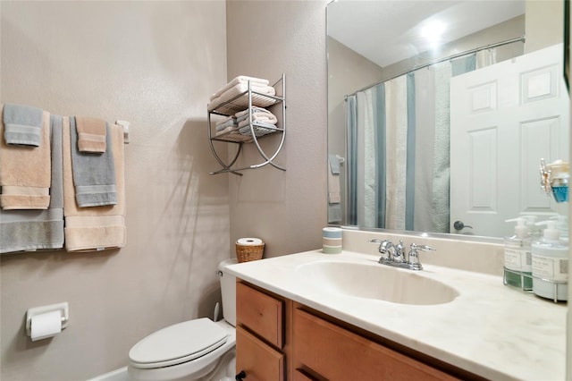 bathroom featuring vanity, toilet, and a shower with shower curtain