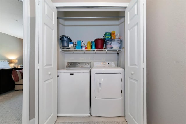 laundry area with light carpet and independent washer and dryer