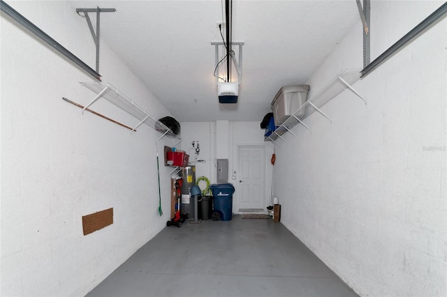 garage with a garage door opener and electric panel