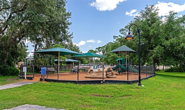 view of jungle gym featuring a lawn