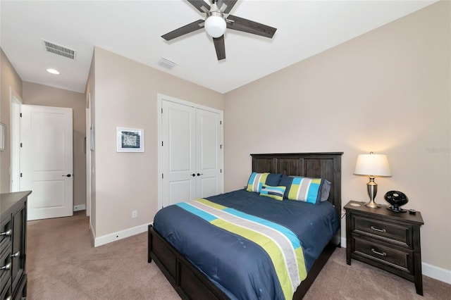 carpeted bedroom featuring ceiling fan and a closet