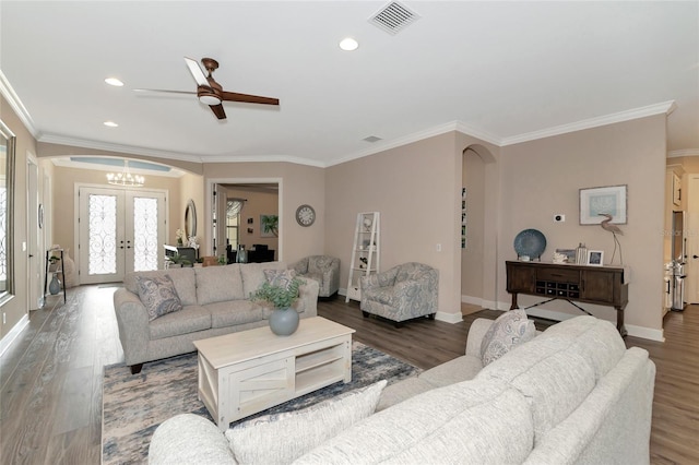 living room with ceiling fan with notable chandelier, french doors, hardwood / wood-style floors, and ornamental molding