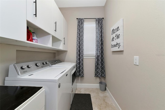 laundry area with light tile patterned flooring, washer and dryer, and cabinets