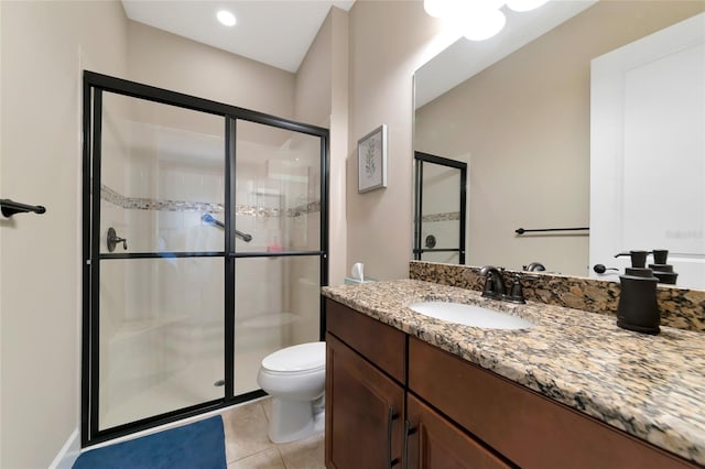 bathroom with tile patterned flooring, a shower with door, toilet, and vanity