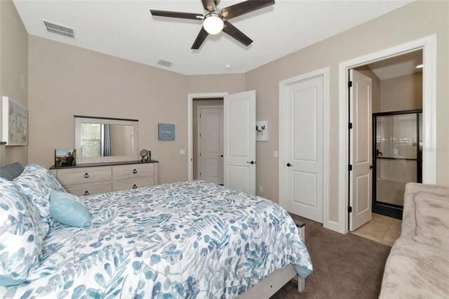 tiled bedroom with ensuite bathroom and ceiling fan