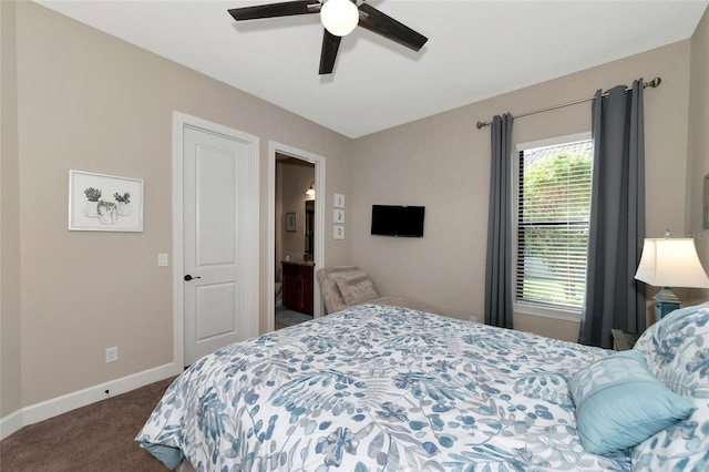 carpeted bedroom with ensuite bath and ceiling fan