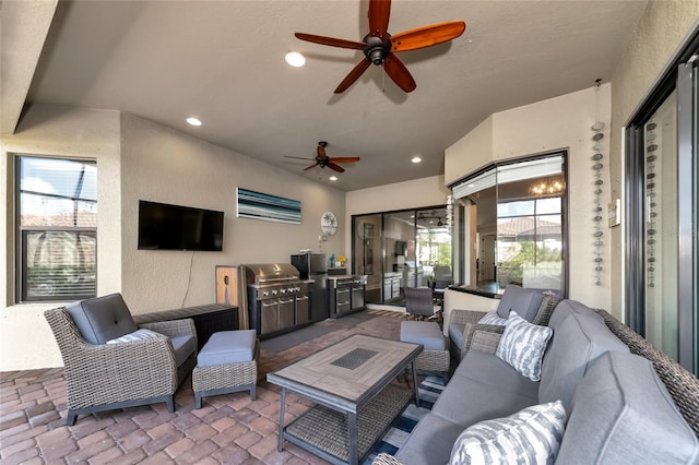 view of patio featuring outdoor lounge area, ceiling fan, and an outdoor kitchen