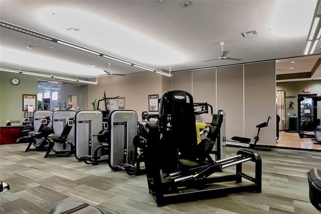 workout area with light hardwood / wood-style floors and ceiling fan