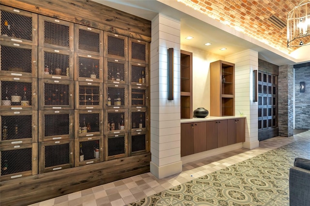 wine area with light tile patterned flooring and brick ceiling