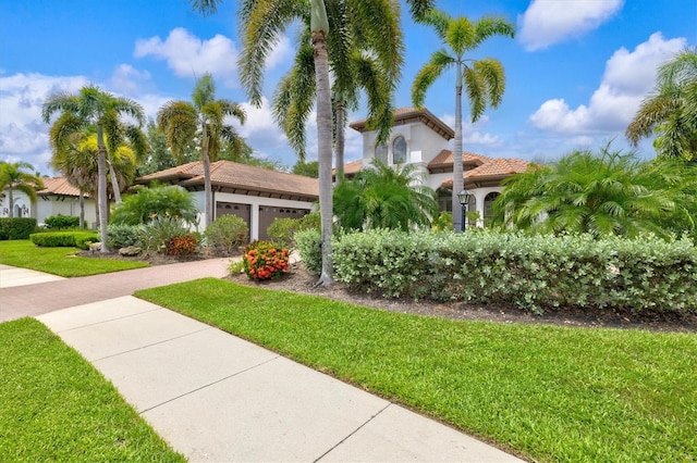 view of front of home featuring a garage and a front yard