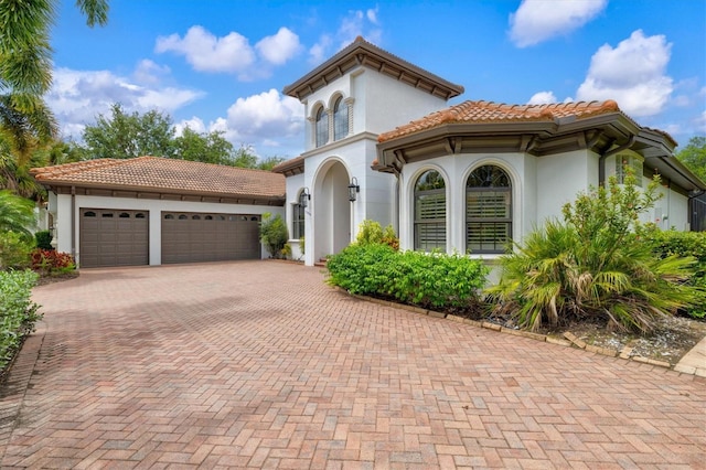 mediterranean / spanish-style home with a garage