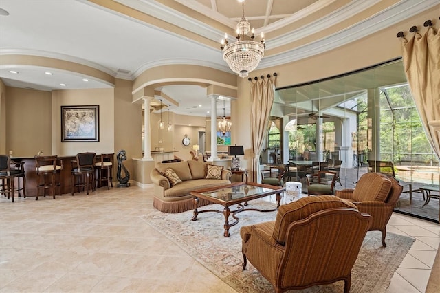 living room with light tile patterned flooring, a notable chandelier, crown molding, decorative columns, and a raised ceiling