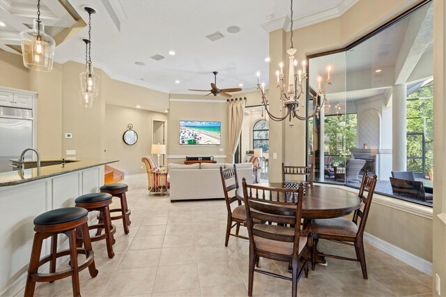 dining area featuring sink, crown molding, ceiling fan with notable chandelier, and light tile patterned floors