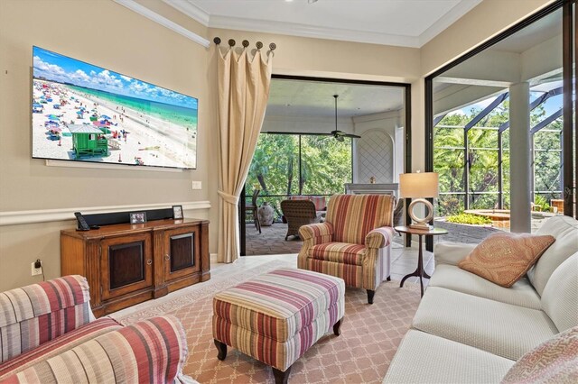 carpeted living room with crown molding and ceiling fan