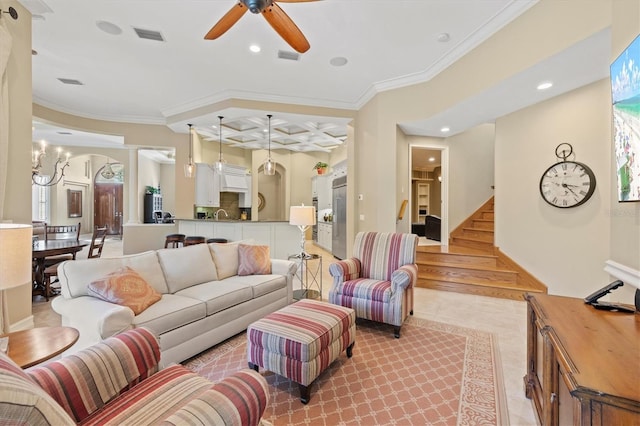 living room featuring light tile patterned flooring, ceiling fan with notable chandelier, and crown molding