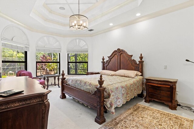 carpeted bedroom with an inviting chandelier, multiple windows, crown molding, and a tray ceiling