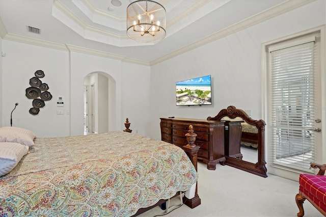 carpeted bedroom with crown molding, a chandelier, a tray ceiling, and access to outside