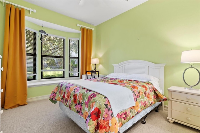 bedroom featuring light carpet and ceiling fan