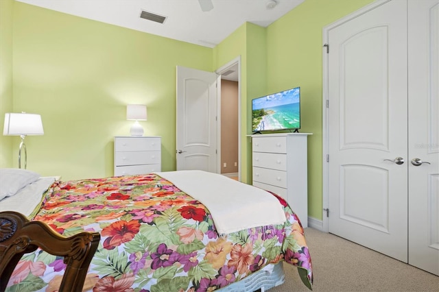 carpeted bedroom with a closet and ceiling fan