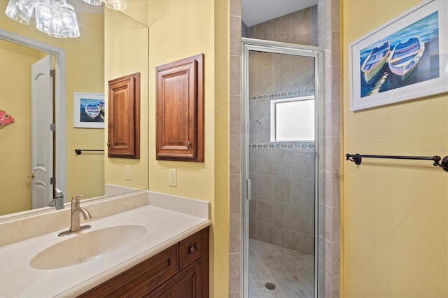 bathroom with vanity and a shower with door