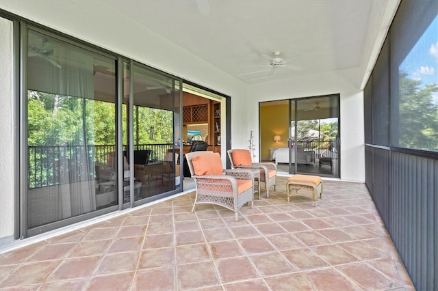 unfurnished sunroom with ceiling fan