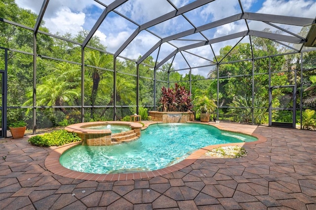 view of swimming pool with a patio, an in ground hot tub, pool water feature, and glass enclosure