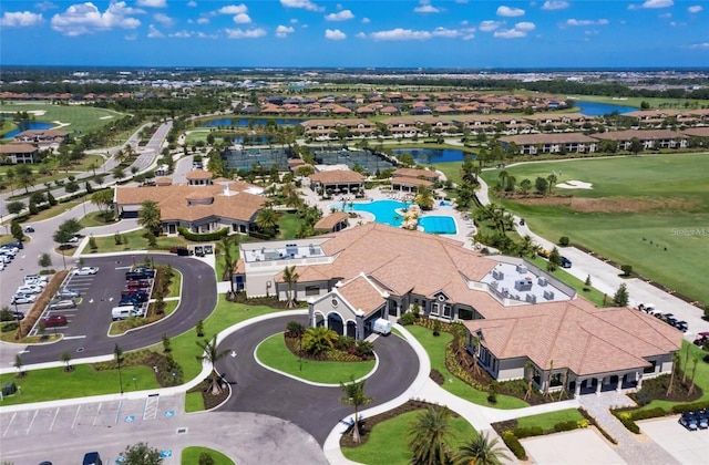 birds eye view of property with view of golf course, a water view, and a residential view