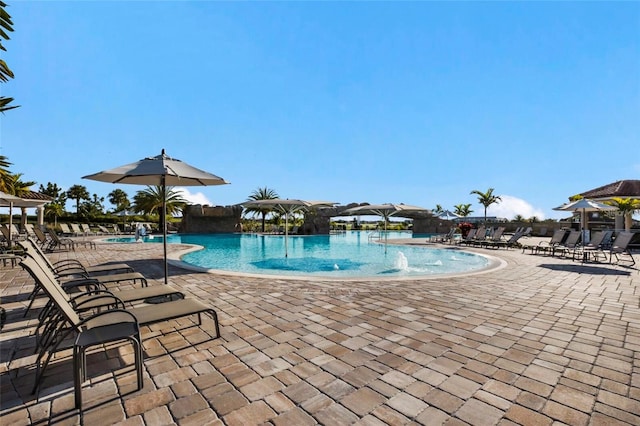 view of pool featuring pool water feature and a patio area