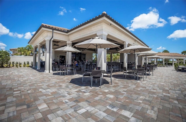 view of patio / terrace with ceiling fan and a gazebo