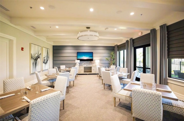 carpeted living room featuring beam ceiling