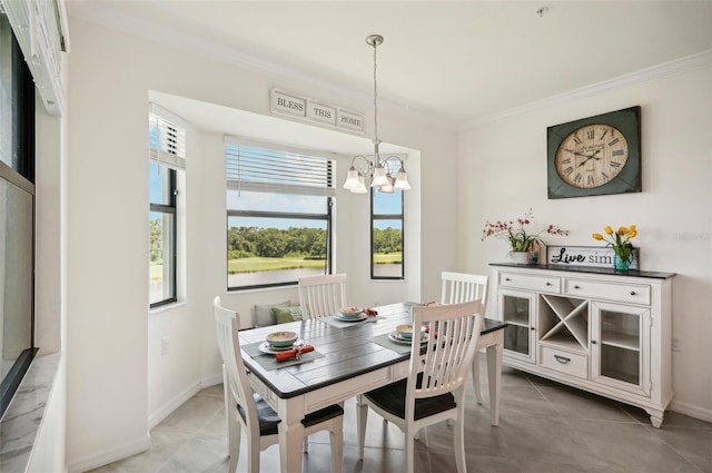 tiled dining room featuring crown molding and a chandelier