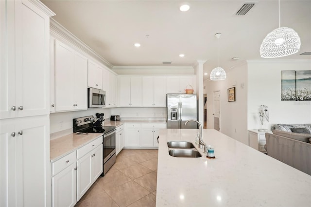 kitchen featuring white cabinetry, sink, stainless steel appliances, and decorative light fixtures