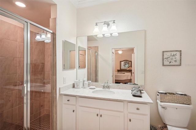 bathroom with toilet, vanity, ornamental molding, and walk in shower