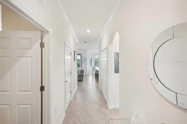 hallway featuring ornamental molding and light tile patterned floors