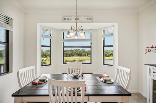 tiled dining area featuring a chandelier, crown molding, and a healthy amount of sunlight