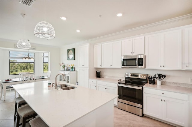 kitchen with a notable chandelier, sink, white cabinetry, and stainless steel appliances