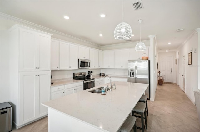 kitchen featuring white cabinets, appliances with stainless steel finishes, a center island with sink, and sink