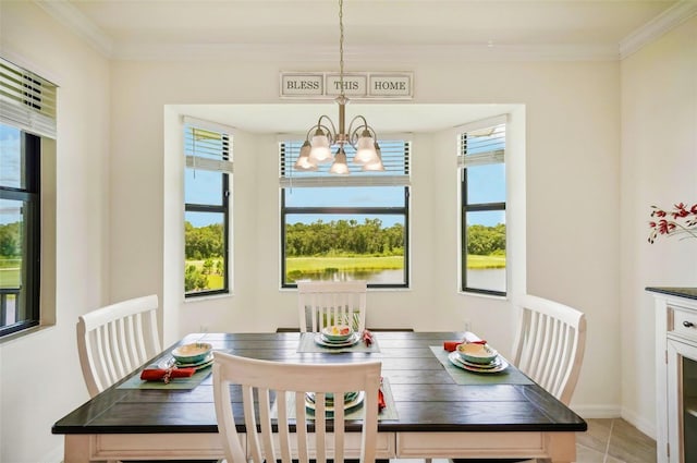 dining space featuring a chandelier, light tile patterned flooring, baseboards, and crown molding