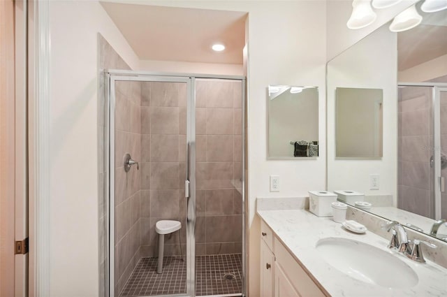 full bath with a stall shower and vanity