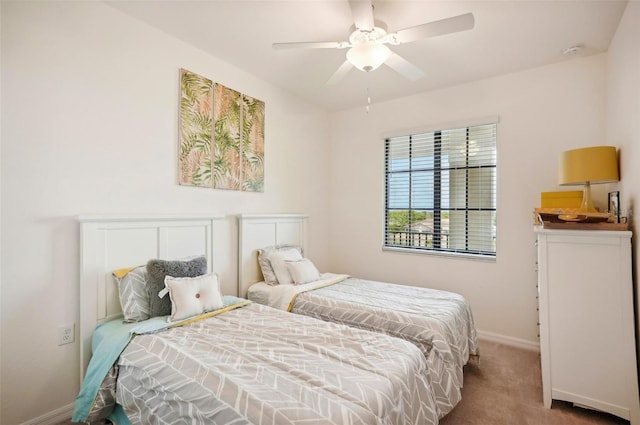 carpeted bedroom with baseboards and a ceiling fan