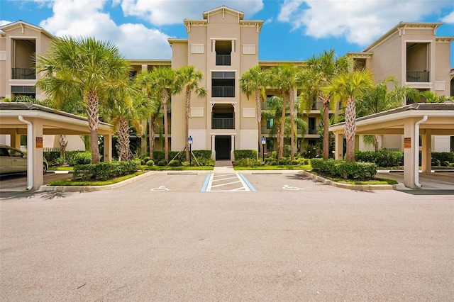 view of building exterior with uncovered parking