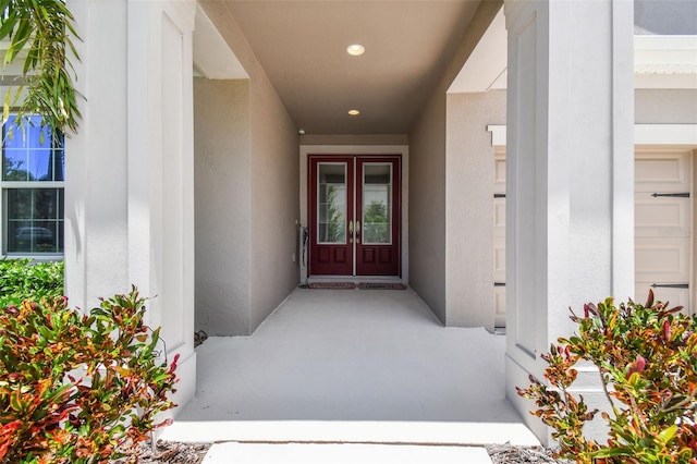 doorway to property featuring french doors and stucco siding